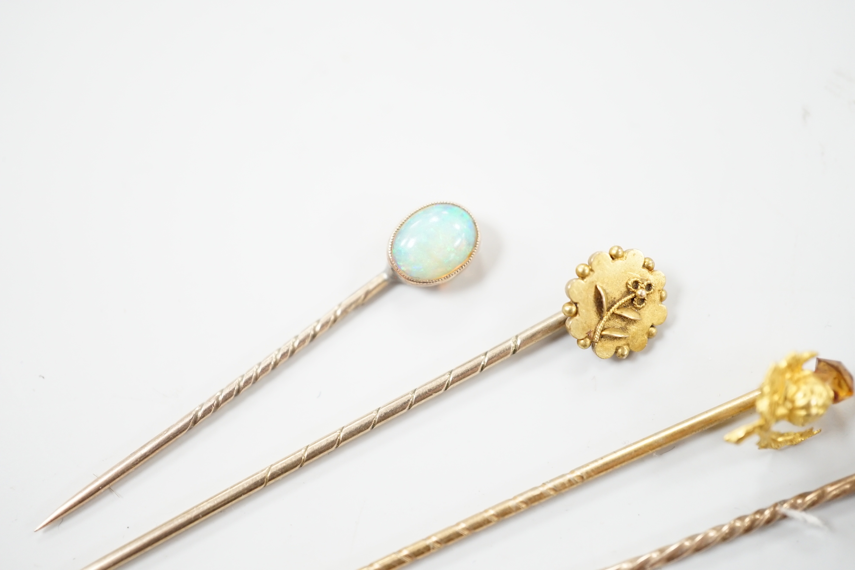 Three early 20th century 15ct stick pins including gem, three similar 9ct stick pins and one other yellow metal and white opal set stick pin, largest approx. 57mm.